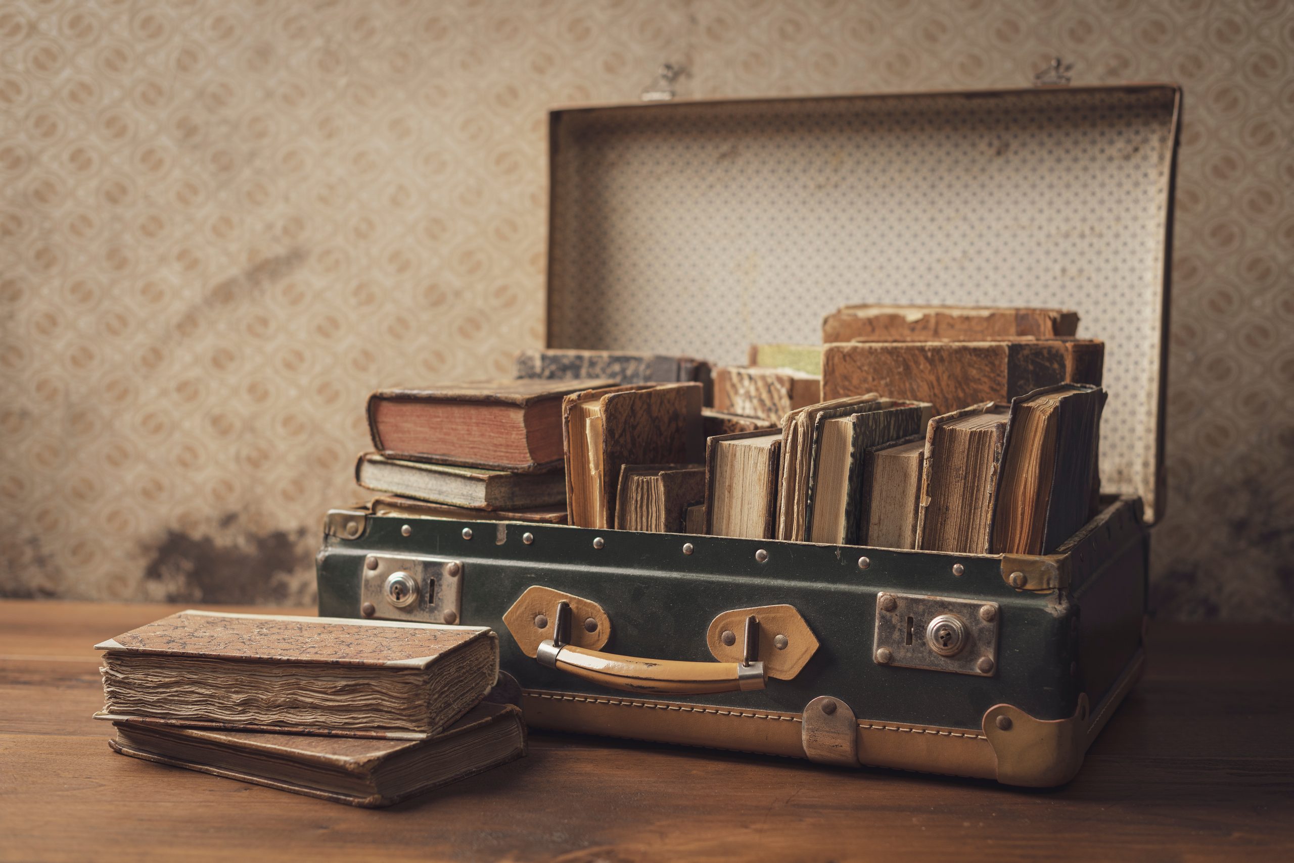 Old,Leather,Suitcase,With,Books,On,The,Floor.,Suitcase,In